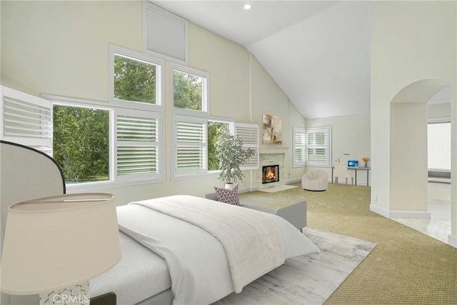 carpeted bedroom featuring high vaulted ceiling