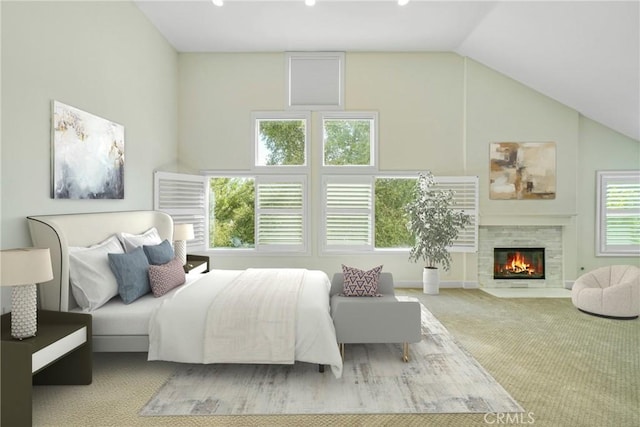 carpeted bedroom with a tile fireplace and lofted ceiling