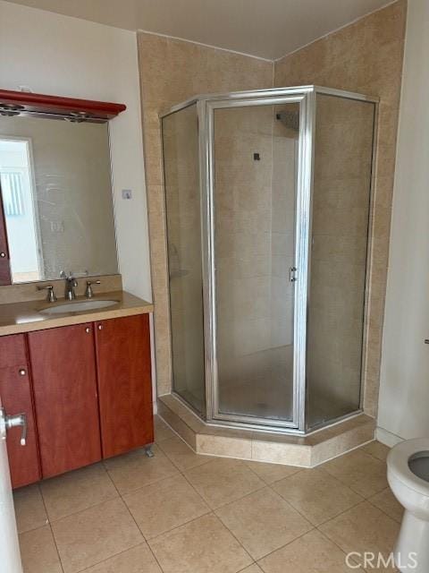 bathroom with vanity, tile patterned floors, and a shower with shower door