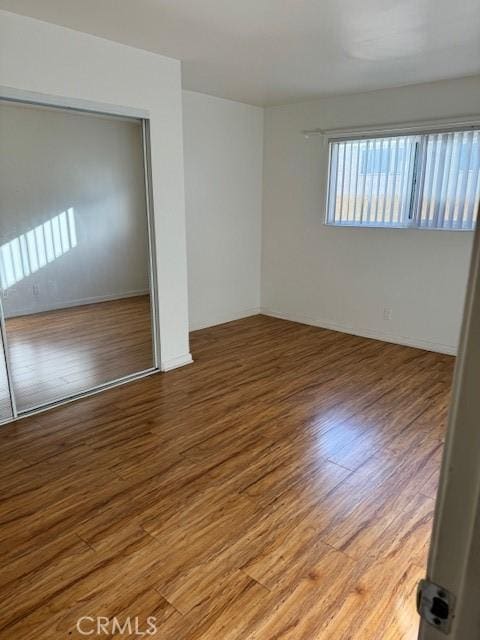 empty room with wood-type flooring