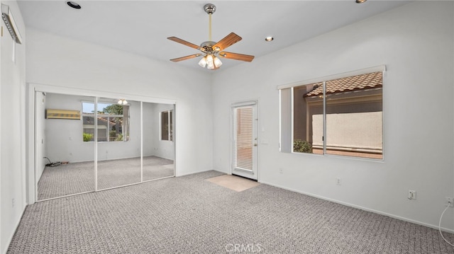 unfurnished bedroom with ceiling fan, a closet, and light carpet