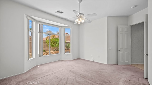 unfurnished room with ceiling fan and light colored carpet