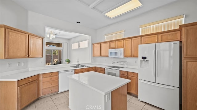 kitchen with light tile patterned flooring, white appliances, sink, a kitchen island, and a chandelier