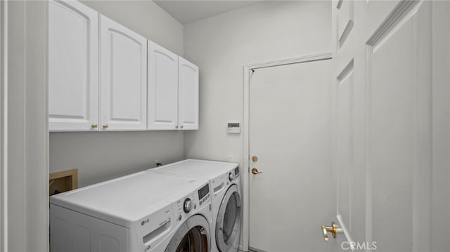 clothes washing area featuring cabinets and washing machine and dryer