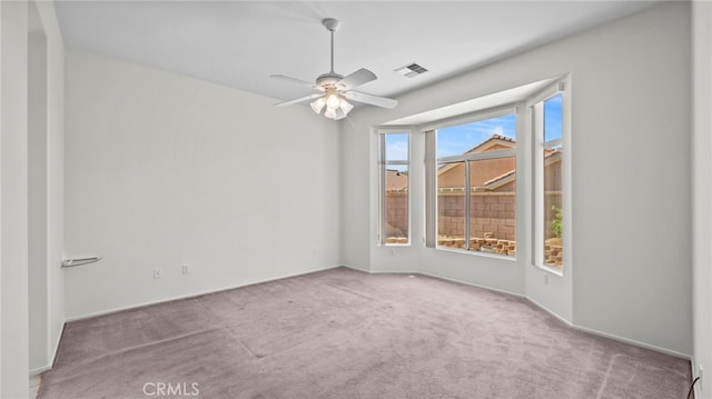 empty room featuring light carpet and ceiling fan