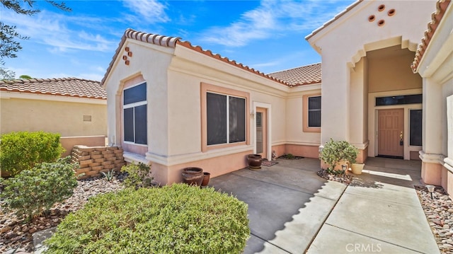 doorway to property with a patio area