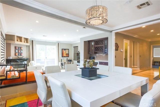 dining area with indoor bar and crown molding