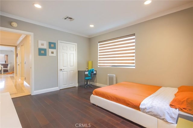 bedroom with radiator heating unit, crown molding, and dark wood-type flooring