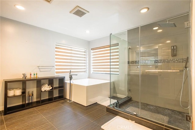 bathroom featuring shower with separate bathtub