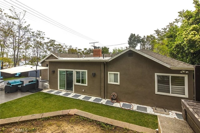 back of property featuring a yard, an outdoor hangout area, and a patio