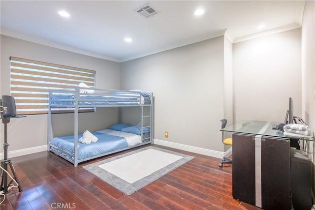 bedroom with ornamental molding and dark wood-type flooring