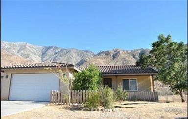 view of front of property with a mountain view and a garage