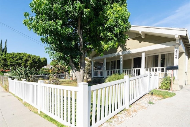 view of side of property featuring covered porch