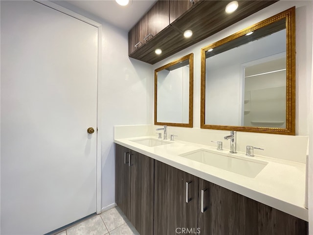 bathroom featuring tile patterned flooring and vanity