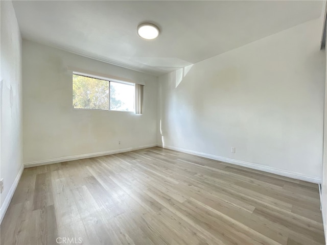 unfurnished room featuring light hardwood / wood-style floors