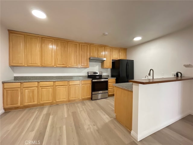 kitchen featuring black fridge, sink, kitchen peninsula, light wood-type flooring, and stainless steel electric range oven