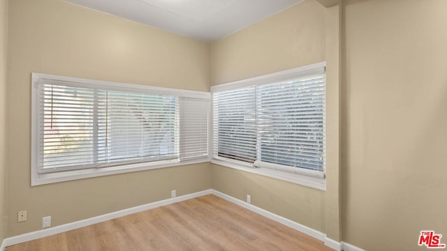 empty room with light hardwood / wood-style flooring