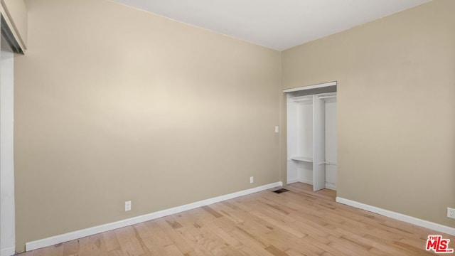 spare room with light hardwood / wood-style flooring