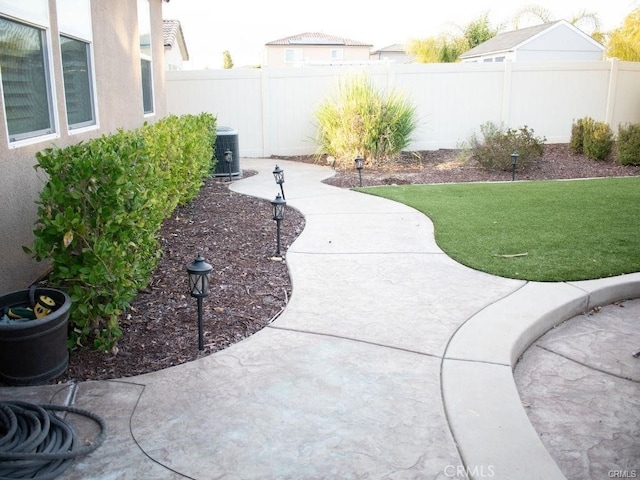 view of yard with a patio and central AC unit