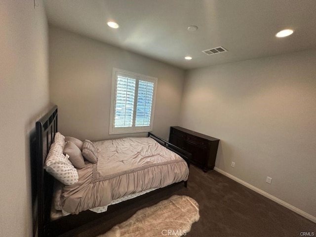 bedroom with dark colored carpet