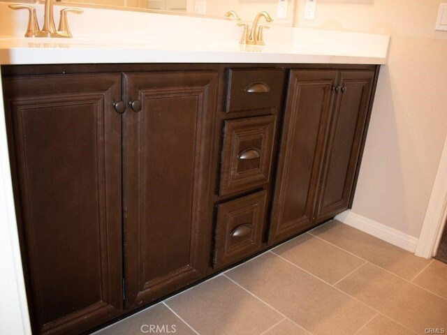 bathroom with tile patterned flooring and vanity