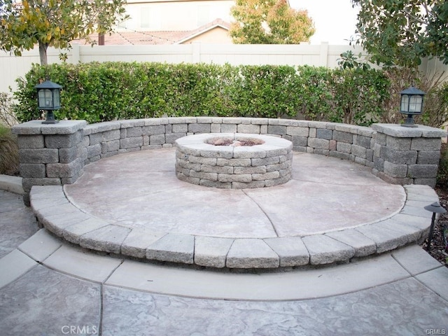 view of patio / terrace featuring an outdoor fire pit