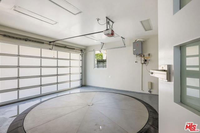 garage featuring electric panel and a garage door opener