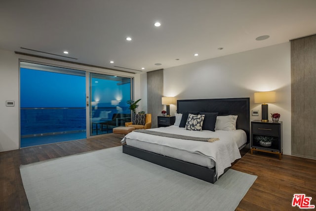 bedroom featuring dark hardwood / wood-style flooring and access to exterior