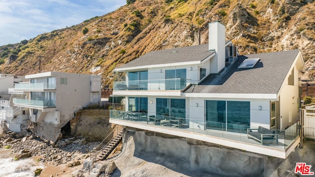 back of house featuring a mountain view