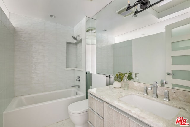 full bathroom featuring toilet, vanity, tile patterned floors, and tiled shower / bath combo