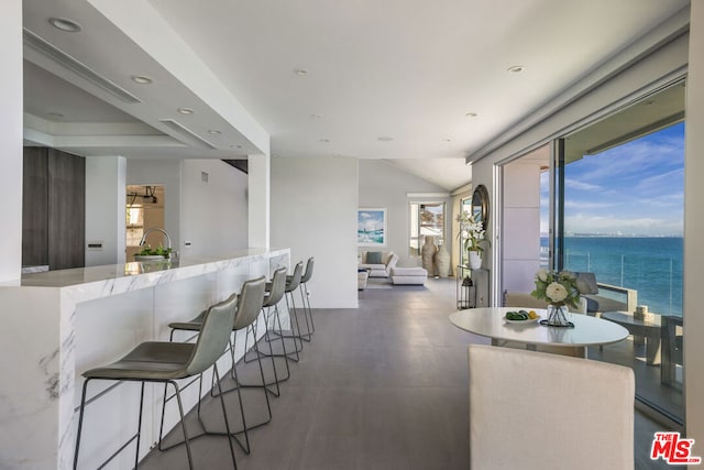 dining area with a water view and sink