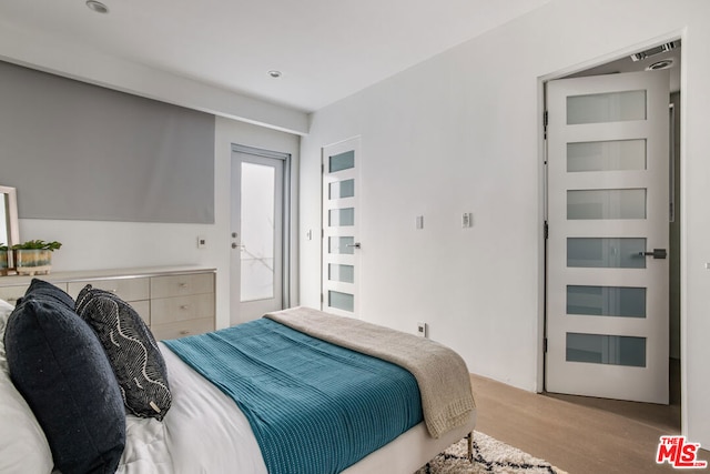 bedroom with light hardwood / wood-style floors