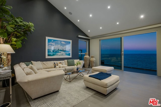 living room featuring a water view and high vaulted ceiling