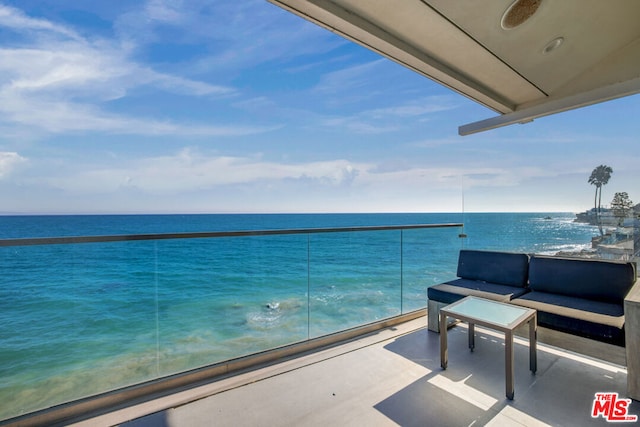 balcony with outdoor lounge area and a water view