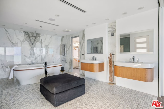 bathroom with vanity, separate shower and tub, and tile walls