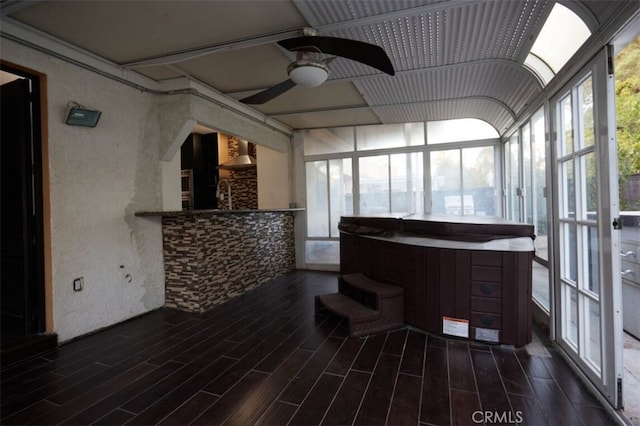 miscellaneous room featuring sink, a wall of windows, and ceiling fan