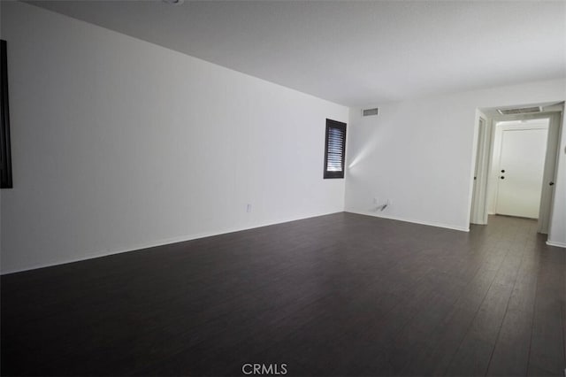 empty room featuring dark wood-type flooring