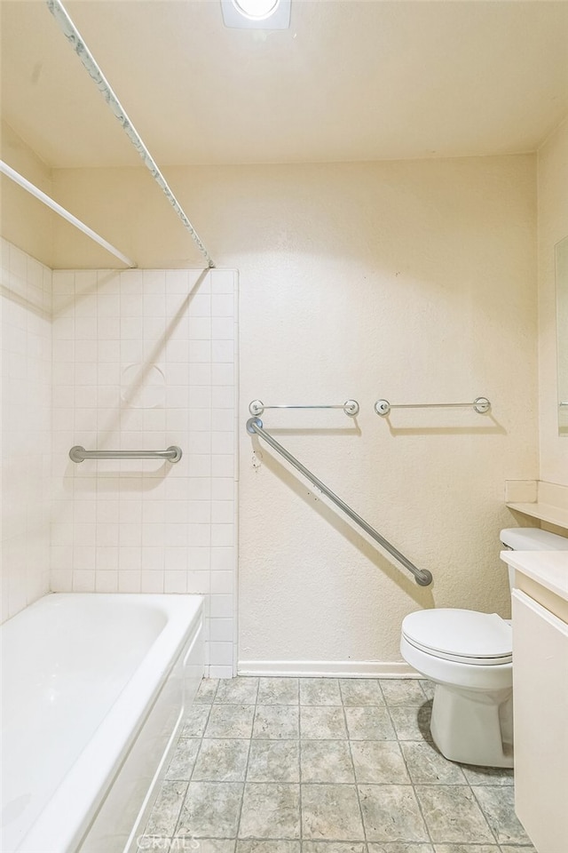 full bathroom featuring tiled shower / bath combo, vanity, and toilet