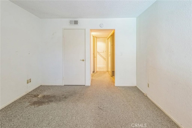 8801 Independence Ave Unit 11, Canoga Park, CA 91304 - spare room featuring carpet flooring, a textured ceiling, and a smoke detector