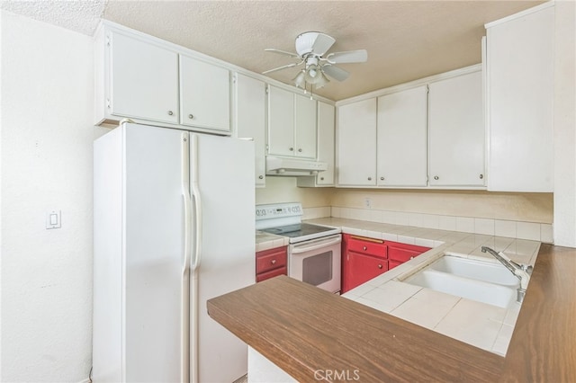 kitchen featuring white appliances, white cabinetry, sink, and ceiling fan