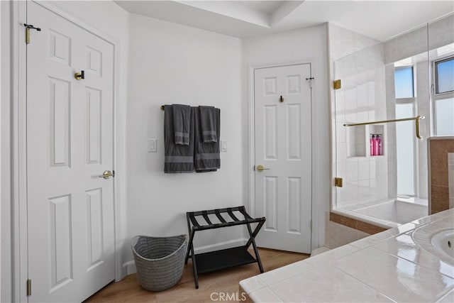 bathroom with walk in shower and hardwood / wood-style flooring