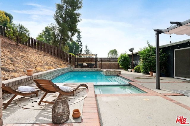 view of swimming pool with an in ground hot tub and a patio