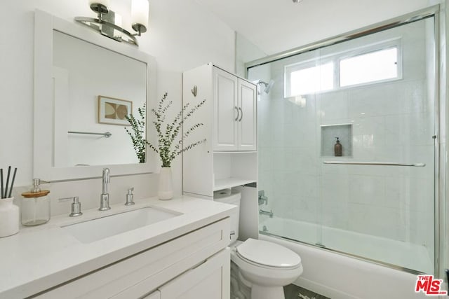 full bathroom featuring vanity, toilet, and enclosed tub / shower combo