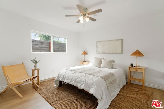 bedroom featuring hardwood / wood-style floors and ceiling fan