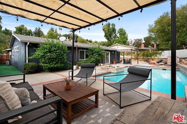 view of pool featuring outdoor lounge area, a patio area, and a jacuzzi