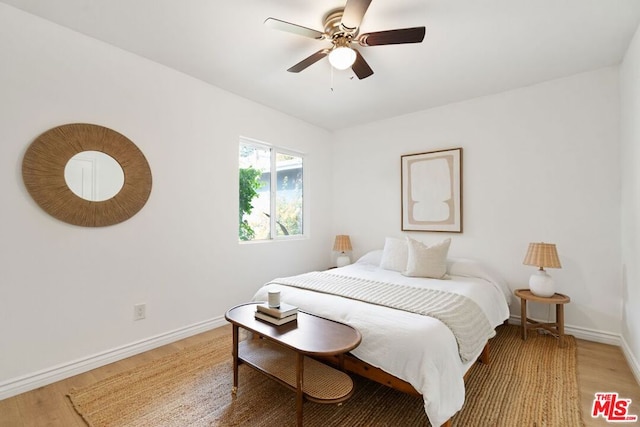 bedroom with ceiling fan and wood-type flooring