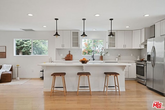 kitchen with plenty of natural light, light wood-type flooring, and appliances with stainless steel finishes