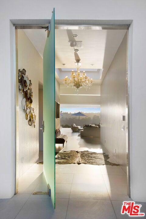 interior space with a notable chandelier and light tile patterned flooring