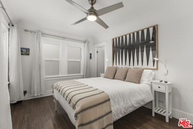 bedroom with dark hardwood / wood-style floors and ceiling fan