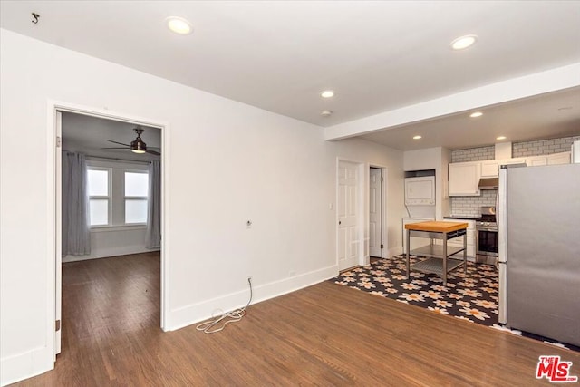 kitchen featuring ceiling fan, backsplash, stainless steel appliances, dark hardwood / wood-style floors, and white cabinets